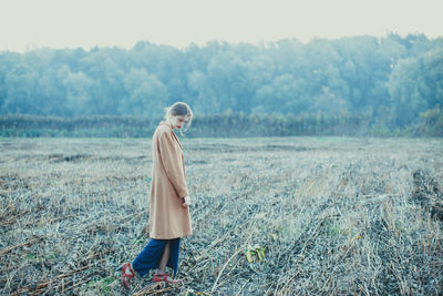 Full length of woman standing on field