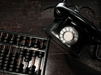 High angle view of old telephone on table