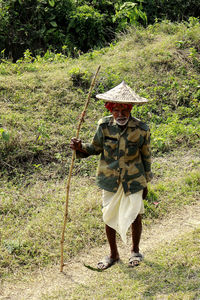 Rear view of woman standing on field