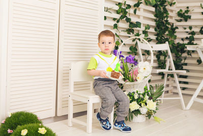 Portrait of cute girl sitting on chair