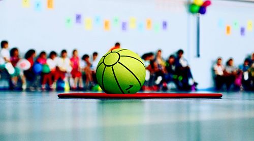 Group of people sitting in sports court