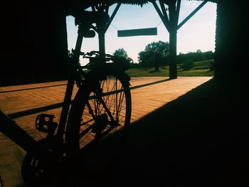 Bicycle parked by tree against sky