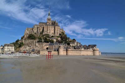 Built structure on beach against sky