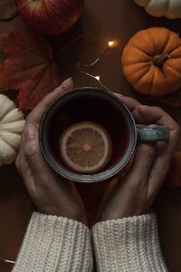 Midsection of woman holding coffee cup