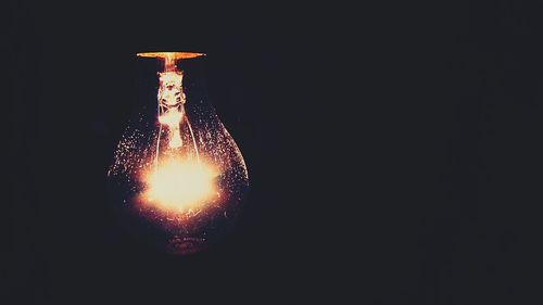 Low angle view of illuminated lights at night