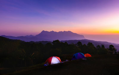 Colorful twilight sky before sunrise at outdoor camping site with camping tents.