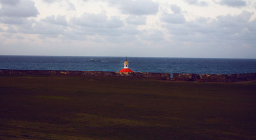 Scenic view of sea against cloudy sky