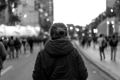 Rear view of people on street at night