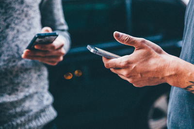 Close-up of man holding smart phone