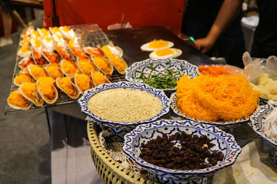 A table with typical colourful thai dishes.