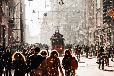 Crowd walking on street in city