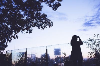 Low angle view of silhouette woman against sky