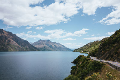 Scenic view of sea and mountains against sky
