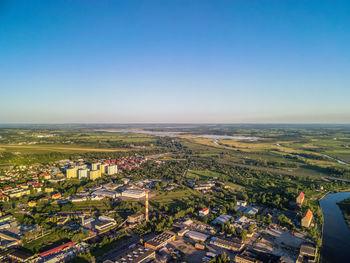 High angle view of cityscape against clear blue sky