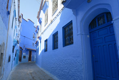 Empty alley amidst buildings in city