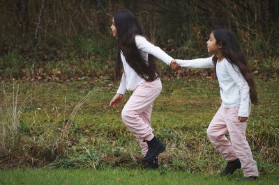 Friends on field in forest