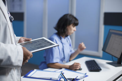 Doctor using digital tablet at office