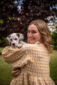 Portrait of young woman with dog