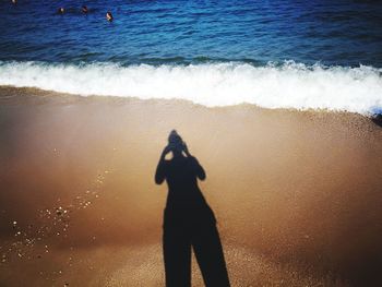 Woman shadow on shore at beach