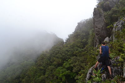 Rear view of man walking on mountain