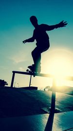 Low angle view of silhouette man skateboarding