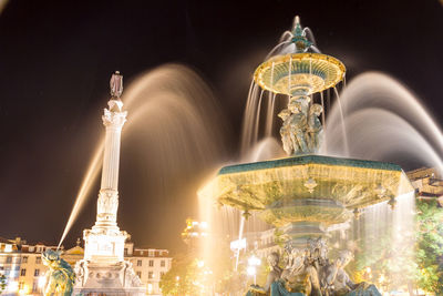 Low angle view of statue at night