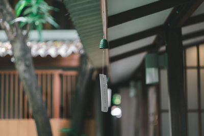 Low angle view of lighting equipment hanging on wall in building