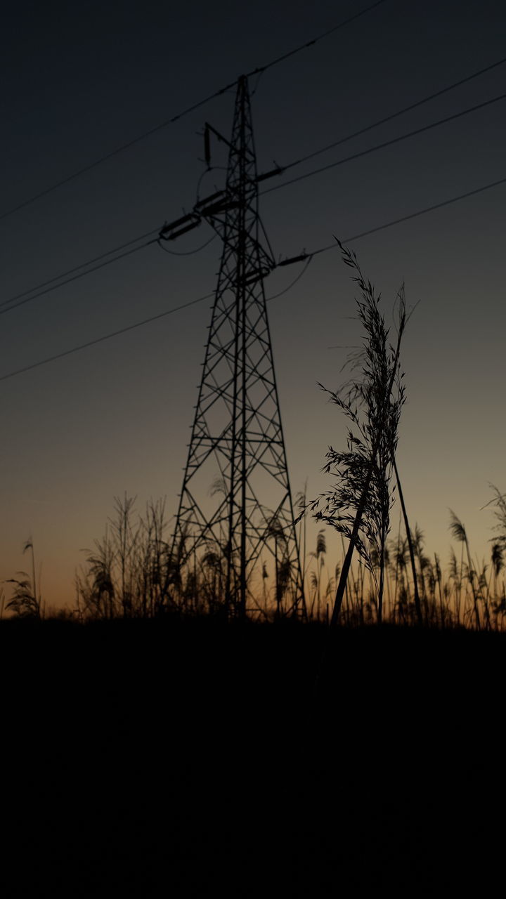 LOW ANGLE VIEW OF SILHOUETTE ELECTRICITY PYLON ON FIELD