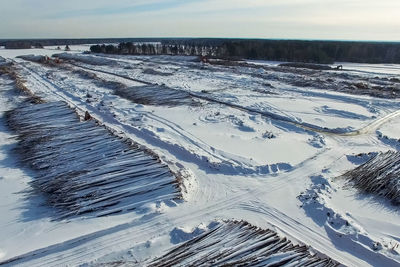 High angle view of snow covered land against sky