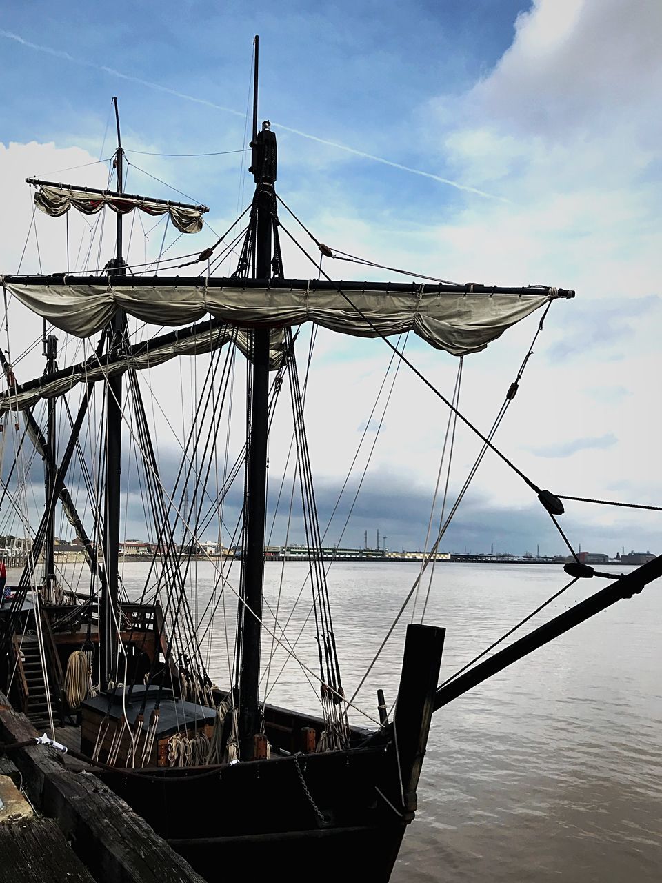 SHIP MOORED AT SEA AGAINST SKY