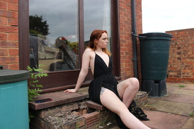 Portrait of young woman sitting on steps