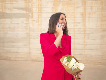 Side view of young woman using mobile phone