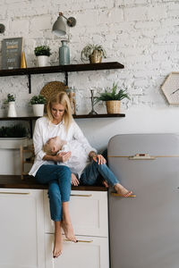 Mother and son sitting in kitchen at home