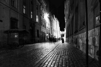 Street amidst buildings at night