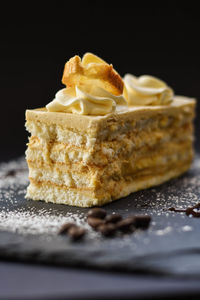 Close-up of cake on table against black background