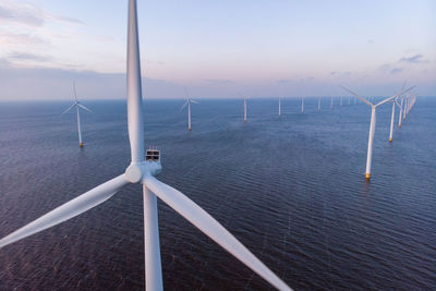 Aerial view windmill turbine scenic view of sea against sky wind mill green energy  global warming