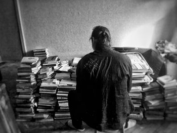 Rear view of a man sitting on floor