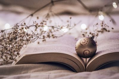 Close-up of christmas decoration on open book at home