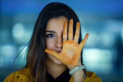 Portrait of woman covering face