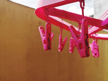 Close-up of pink toy hanging on wall