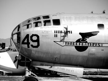 Airplane on airport runway against sky