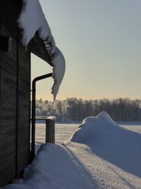 Low section of man against frozen lake during winter