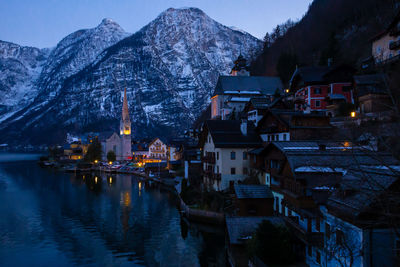 View of beautiful hallstatt lake and famous church during late evening after sunset in early spring