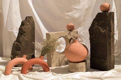 Earthenware vases and objects, pastel terracotta colors, with still life like vegetation
