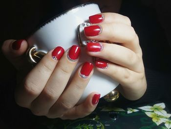 Cropped image of woman holding cup