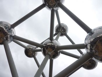 Low angle view of electric lamp against sky