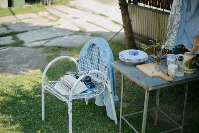 High angle view of empty chairs and table on field