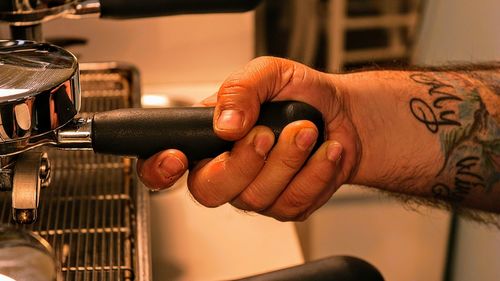 Cropped hand of man playing piano