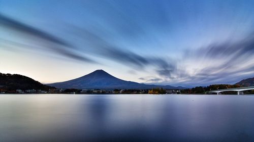 Scenic view of lake against sky at dusk