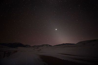 Scenic view of landscape against sky at night